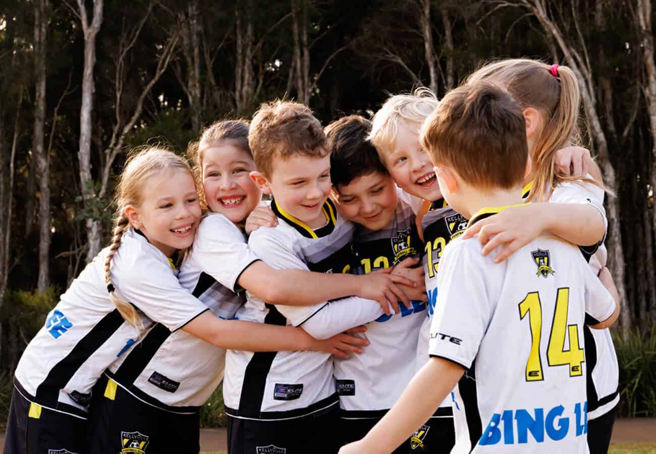 a young kellyville united football team from the minis program enjoying a group hug