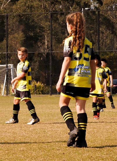 kellyville united players on a football field during grading